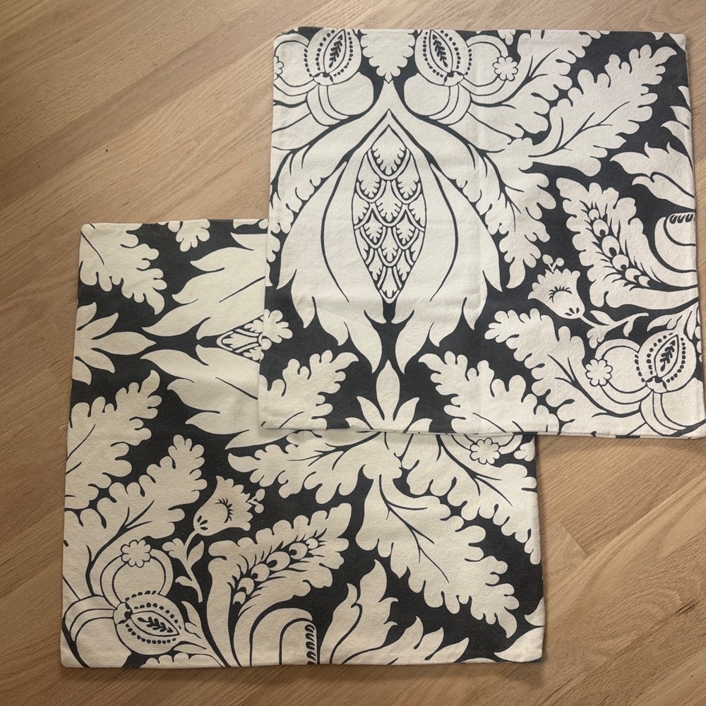 Two Pottery Barn dark gray and white floral pillow covers.